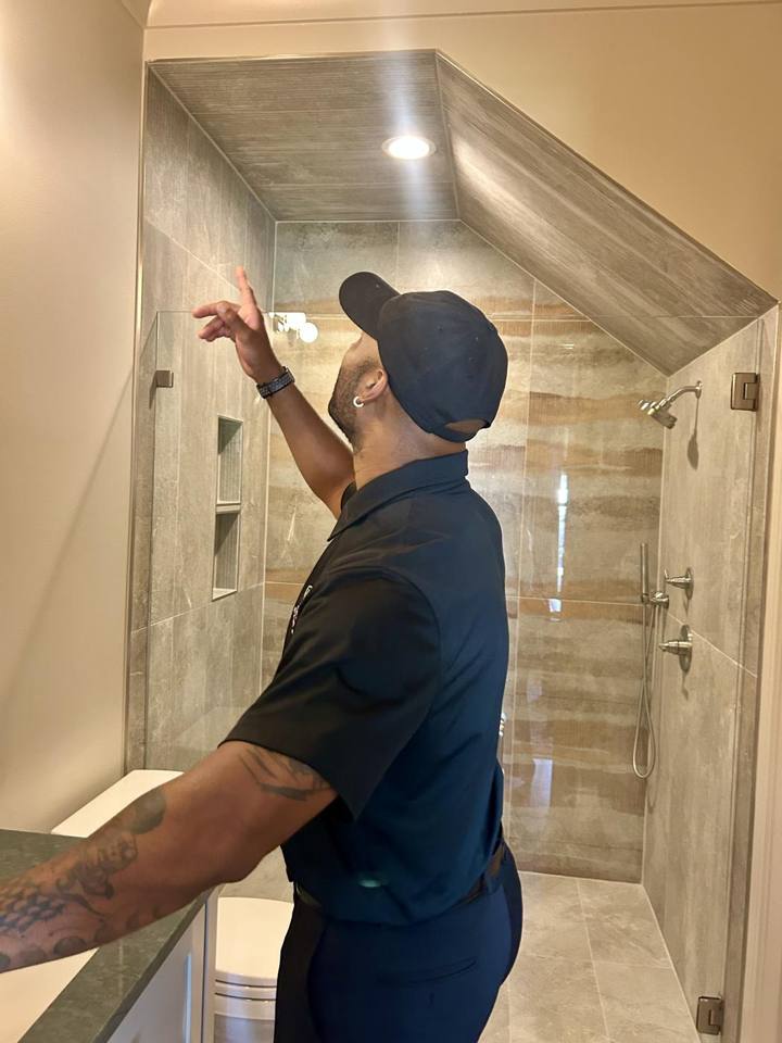 David looking closely at the shower enclosure during an interior inspection